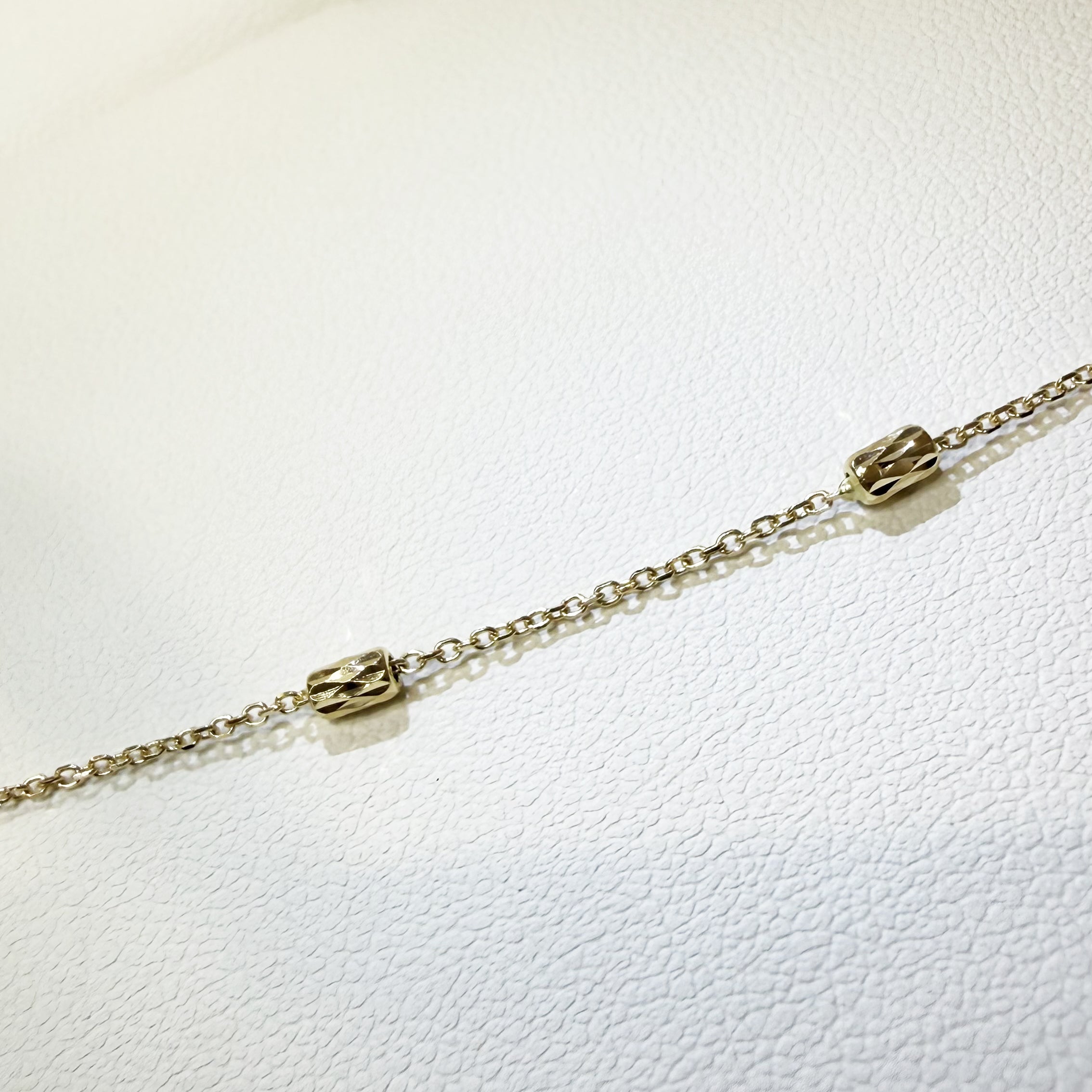 BRACCIALE BABY CON CILINDRETTI SFACCETTATI IN ORO GIALLO 18KT (750)
